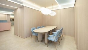 A modern dining area with a round table and six chairs, a light-colored ceiling, and a visible kitchen area in the background. - Hanting Hotel Shanghai The Bund Jiangxi Middle Roa (Shanghai)