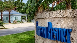 A sign for the "MIRRIFANKE RESTORT" with a house in the background. - New Caribbean home.  Resort access to pool (Islamorada)
