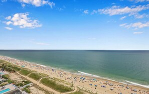 A beach with a clear sky, a pool area, and beach umbrellas. - Penthouse with Amazing views! (Ocean City)