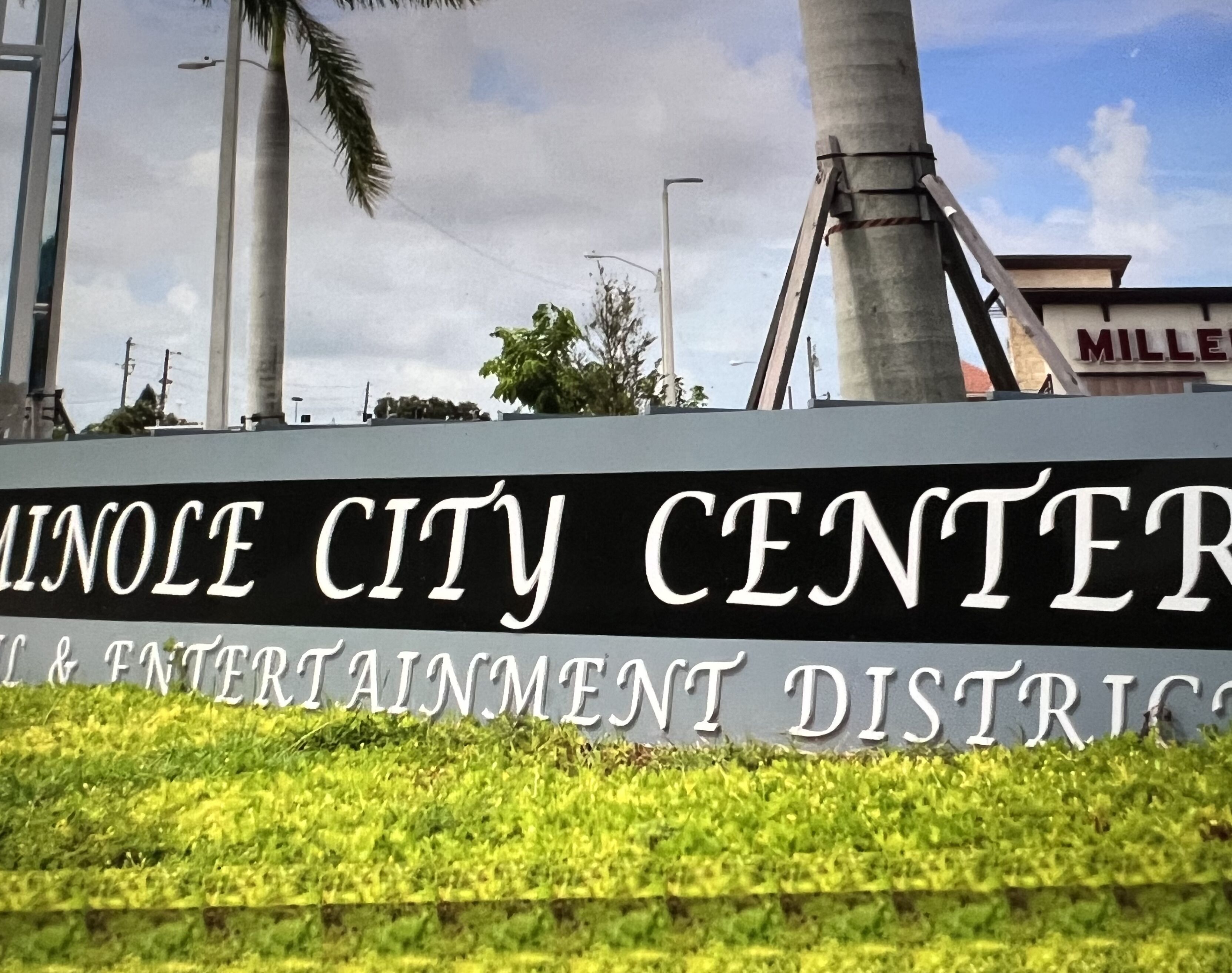 A sign for the UNOLE CITY CENTER & ENTERTAINMENT DISTRICT.
