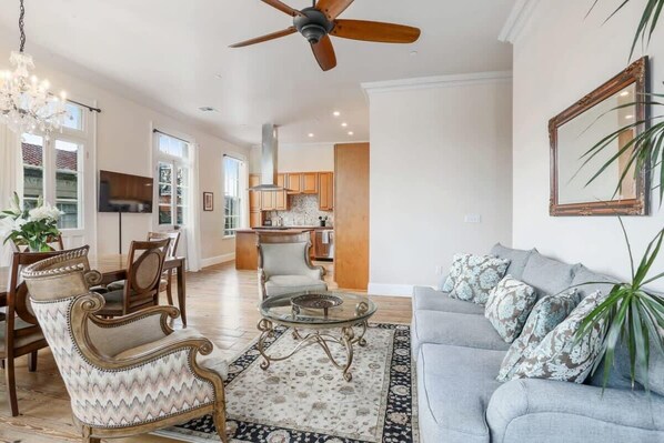 A spacious living room with a sofa, armchairs, and a coffee table.