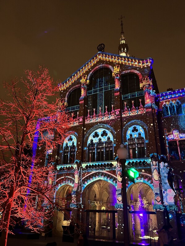 A building with ornate architecture and illuminated windows at night.