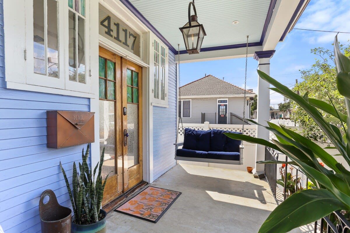 A porch with a mailbox, a swing, and a door marked "4117".