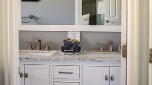 A bathroom with a vanity, a mirror, and a light fixture. - Highland Hideaway, Room for everyone, central to everything (Highland)