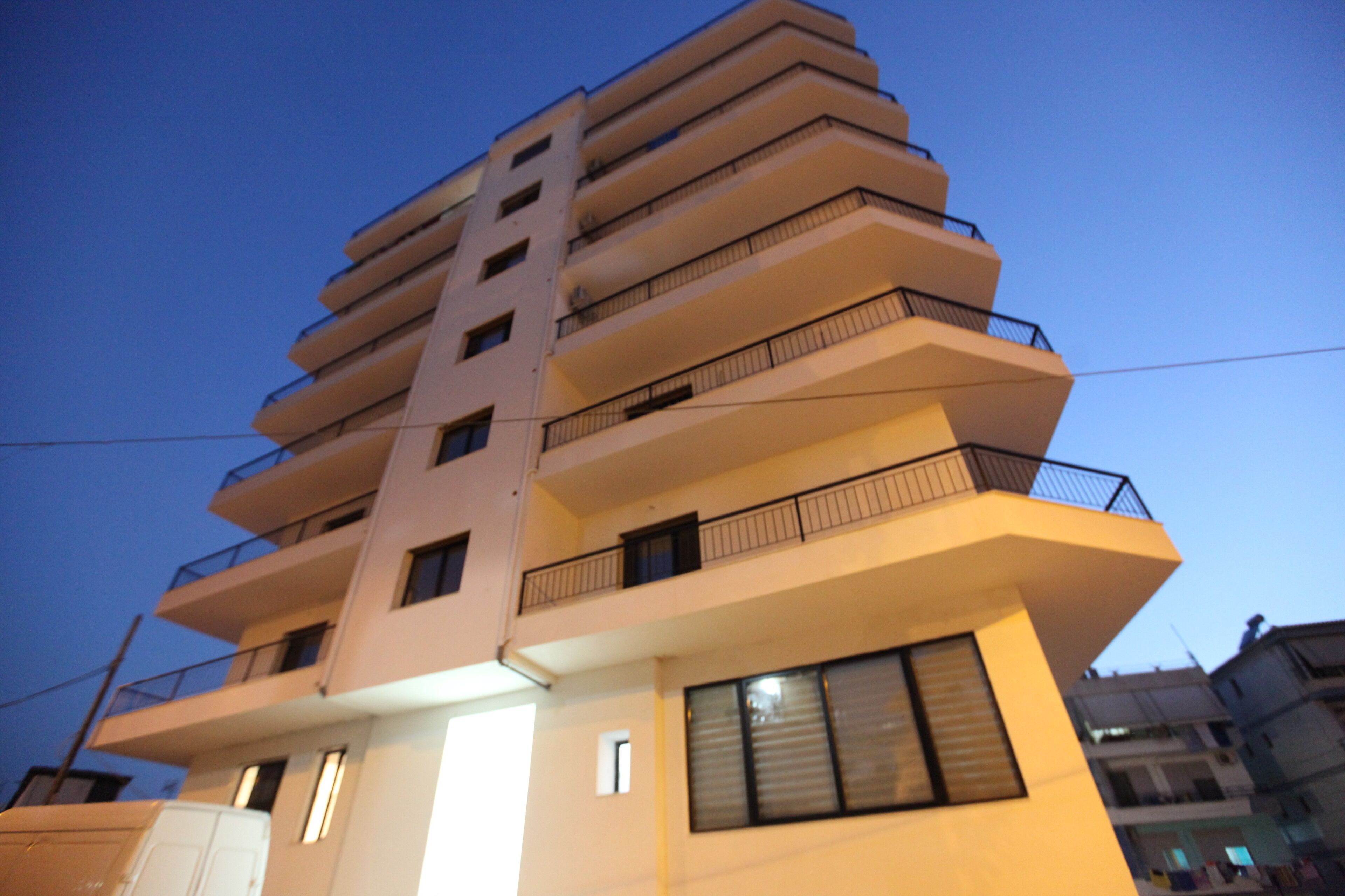 A multi-story building with balconies and windows.