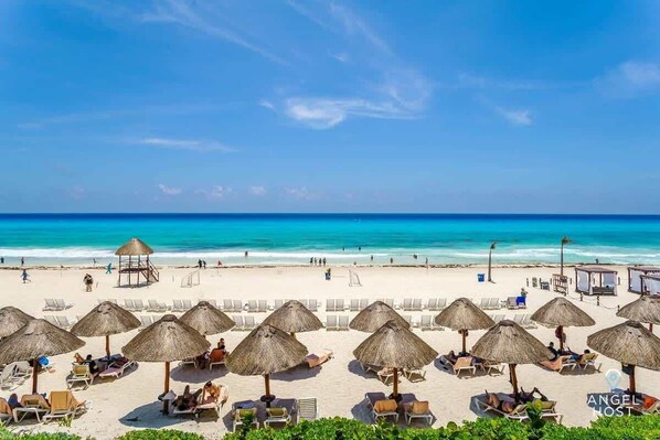 On the beach, sun loungers, beach towels