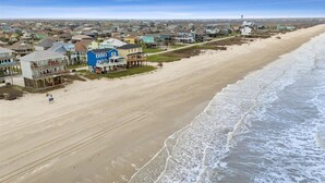 A coastal residential area with beachfront properties, including houses with balconies and a beach in the foreground. - Shore is Fine - Beachfront, AwesomeViews (Port Bolivar)