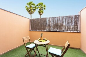 Enjoy a casual meal or refreshing drink in this outdoor space with a round table and two chairs.