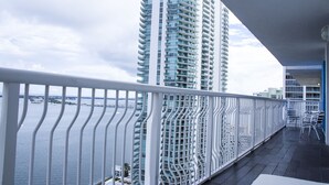A balcony with a view of a tall building and a body of water. - **NEW** Ocean Front 3 Bedroom Apartment in the heart of Brickell (Miami)