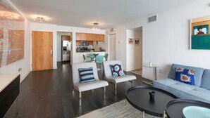 A modern living room with a sofa, two armchairs, a coffee table, and a dining area in the background. - **NEW** Ocean Front 3 Bedroom Apartment in the heart of Brickell (Miami)