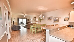 A spacious kitchen with a dining area, wooden flooring, and a chandelier. - Lake & Pool View in the Heart of Myrtle Beach, SC-Magnolia Pointe-Myrtlewood (Myrtle Beach)