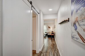 Enter a cozy dining area with a table, chairs, and a lamp.