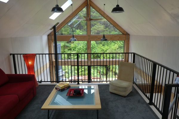 Mezzanine living space looking into bush and over void