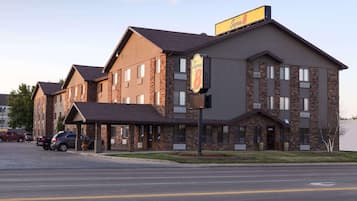 A hotel with a brick facade, multiple windows, and a sign indicating it is a Super 8 hotel.