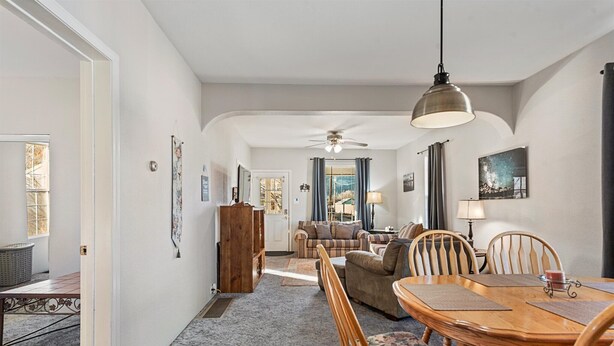 A spacious living room with a dining area, a ceiling fan, and a large window. - Walking Distance to Town__Discount Ski Passes __TRAVELERS WELCOME (La Grande)
