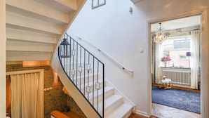 A staircase with a white railing and star-shaped accents, leading to a landing with a view of the outside. - Stunning home in Göteborg with sauna (Göteborg)