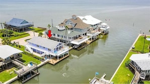 A waterfront property with multiple buildings connected by walkways over water.