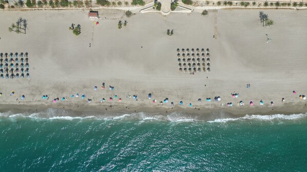 On the beach, sun-loungers