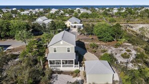 A residential area with houses, a sandy beach, and a clear view of the ocean. - Shimmering Tides~Golf Cart~Secluded (Port St. Joe)