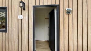 A wooden exterior with a door leading to an interior hallway. - Lovely home in Heinkenszand with WiFi (Heinkenszand)
