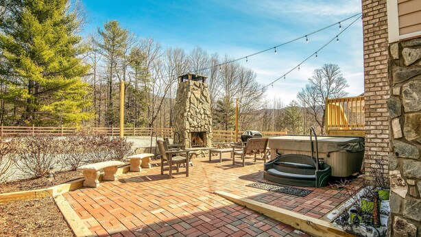 A patio with a stone fireplace, outdoor seating, and a grill. - Fantastic for a small family or multiple families! 
Also check vrbo.com/3702514 (Banner Elk)