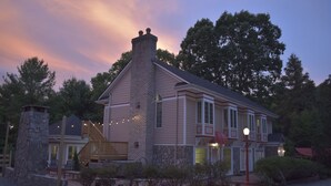 A two-story house with a stone chimney, wooden deck, and a well-maintained garden. - Fantastic for a small family or multiple families! 
Also check vrbo.com/3702514 (Banner Elk)