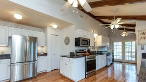 A spacious kitchen with white cabinets, stainless steel appliances, and a wooden floor. - Fantastic for a small family or multiple families! 
Also check vrbo.com/3702514 (Banner Elk)