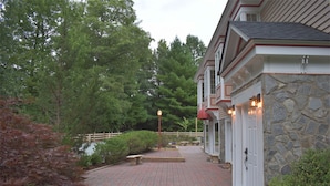 A brick pathway leading to a building with stone walls and a wooden fence. - Fantastic for a small family or multiple families! 
Also check vrbo.com/3702514 (Banner Elk)