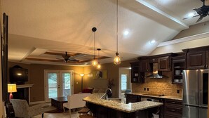 A spacious kitchen with a large island, dark cabinetry, and a modern design. - Minutes from Destin Beaches (Fort Walton Beach)