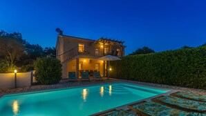 A two-story house with a swimming pool, outdoor seating, and a well-maintained garden. - Holiday home with seaview (Vrh)