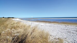 A beach with a signpost, sandy dunes, and a clear sky. - 5 bedroom nice home in Hadsund (Hadsund)