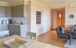 Relax in this inviting living space with a dining area, kitchen, and cozy seating area.