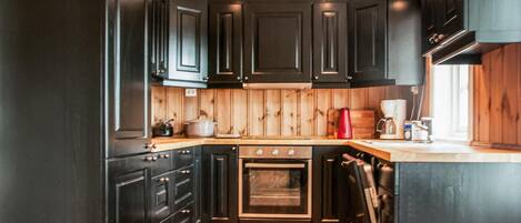 Fridge, stovetop, dishwasher, coffee/tea maker