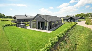 A modern residential building with a covered patio and a well-maintained lawn. - Stunning home in Haderslev with sauna (Haderslev)