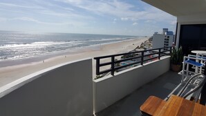 A balcony with a view of a beach and ocean. - 2/2 OCEANFRONT 8th Floor Unit with Open Pool (Daytona Beach)