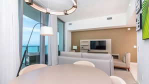 A modern hotel room with a round dining table, a sofa, a TV, and a balcony with a view. - Hyde Resort Hollywood Full Amenities BOOK NOW! (Hollywood)