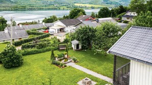 A residential area with houses, a small pond, and a lake in the background. - Gorgeous home in Vestnes with WiFi (Vestnes)