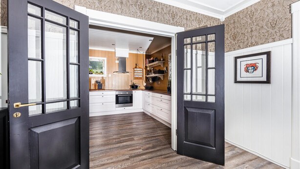 A modern kitchen with white cabinetry, a built-in oven, and a wooden floor. - Gorgeous home in Vestnes with WiFi (Vestnes)
