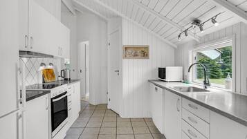 Fridge, stovetop, dishwasher, coffee/tea maker