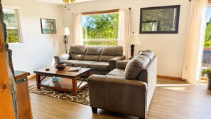 A living room with a sofa set, a coffee table, and a lamp.