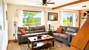 A living room with a sofa set, a coffee table, and a ceiling fan. - The Farmhouse-Beautiful Mountain Views (Palmer)