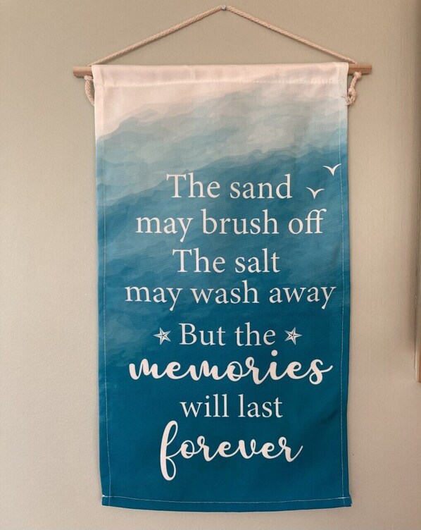 A wall hanging with a quote about memories. - Beautifully Decorated, 3 King Master Bedrooms, AND a Heated Pool by the Ocean (Ocean Isle Beach)
