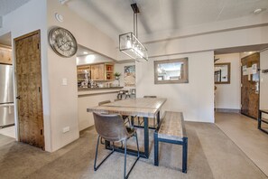 A spacious kitchen with a large island, wooden cabinets, and a clock on the wall. - Village at Breckenridge - Shavano Unit 2603 Ski In/Out (Breckenridge)