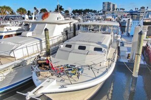 Boats docked at the marina, secured by mooring lines and bollards.