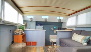 Relax in a cozy living area with a cushioned sofa and small table, perfect for unwinding.