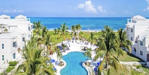 Relax by the pool surrounded by palm trees and enjoy the ocean view.