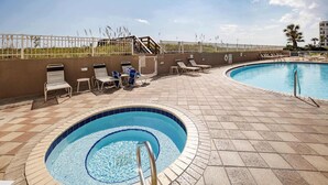 A swimming pool with a sunbathing area and a small hot tub. - Island Princess 719🌊Gulf Views🏖️Free Beach Setup (Fort Walton Beach)