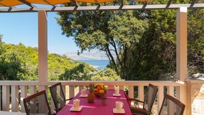 A table set for two with a view of a coastal landscape.
