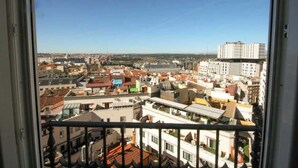 A cityscape viewed from a balcony with a clear sky. - Gran Vía Terrace w/ Royal Palace Views, Central (Madrid)