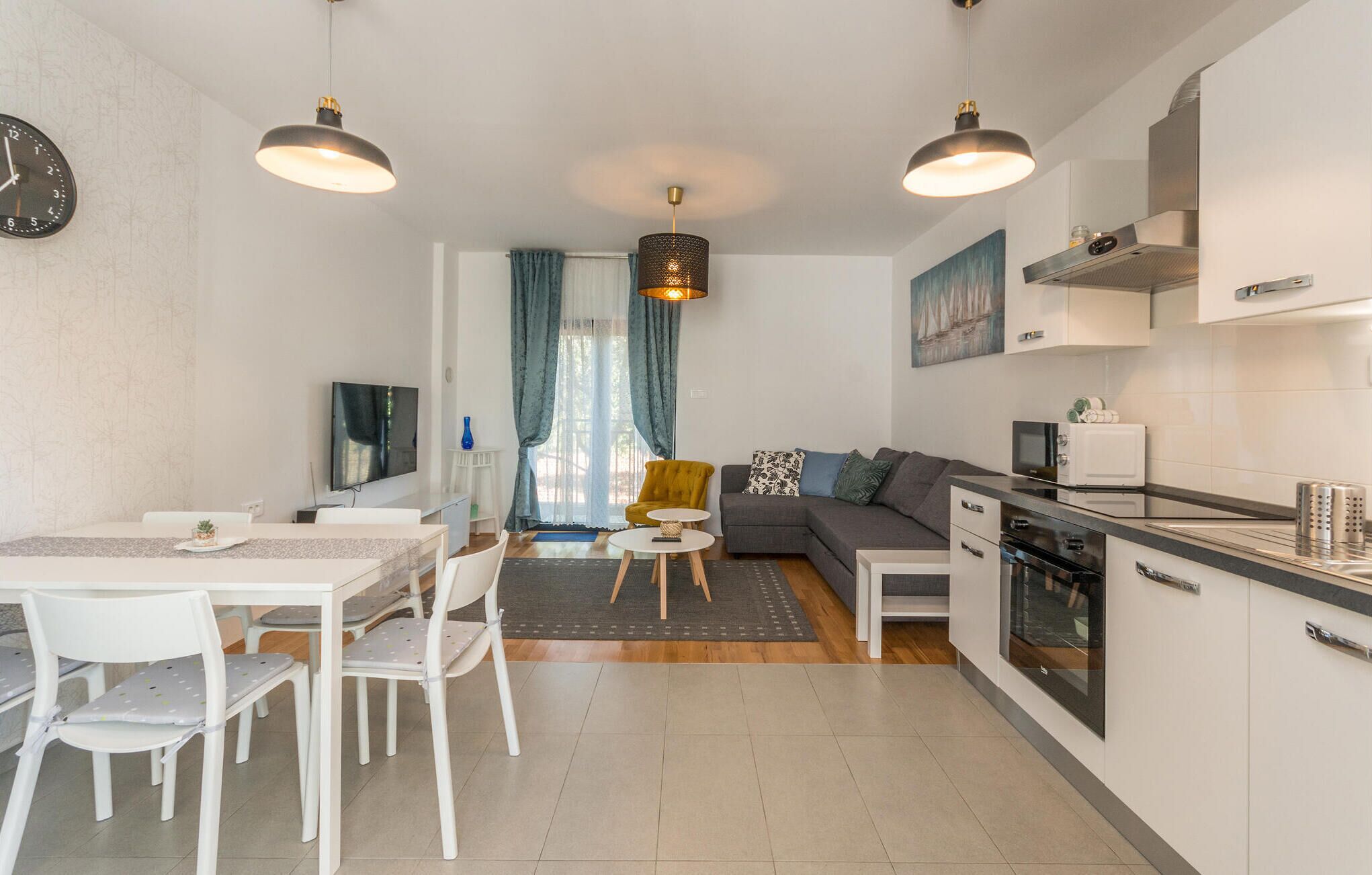Een modern appartement met een eetgedeelte, een woonkamer en een keuken.